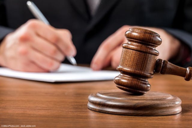 Gavel with judge writing down notes in background | Image Credit: © BillionPhotos.com - stock.adobe.com